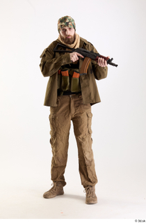 Andrew Elliott Insurgent Pose with Gun holding gun standing whole…